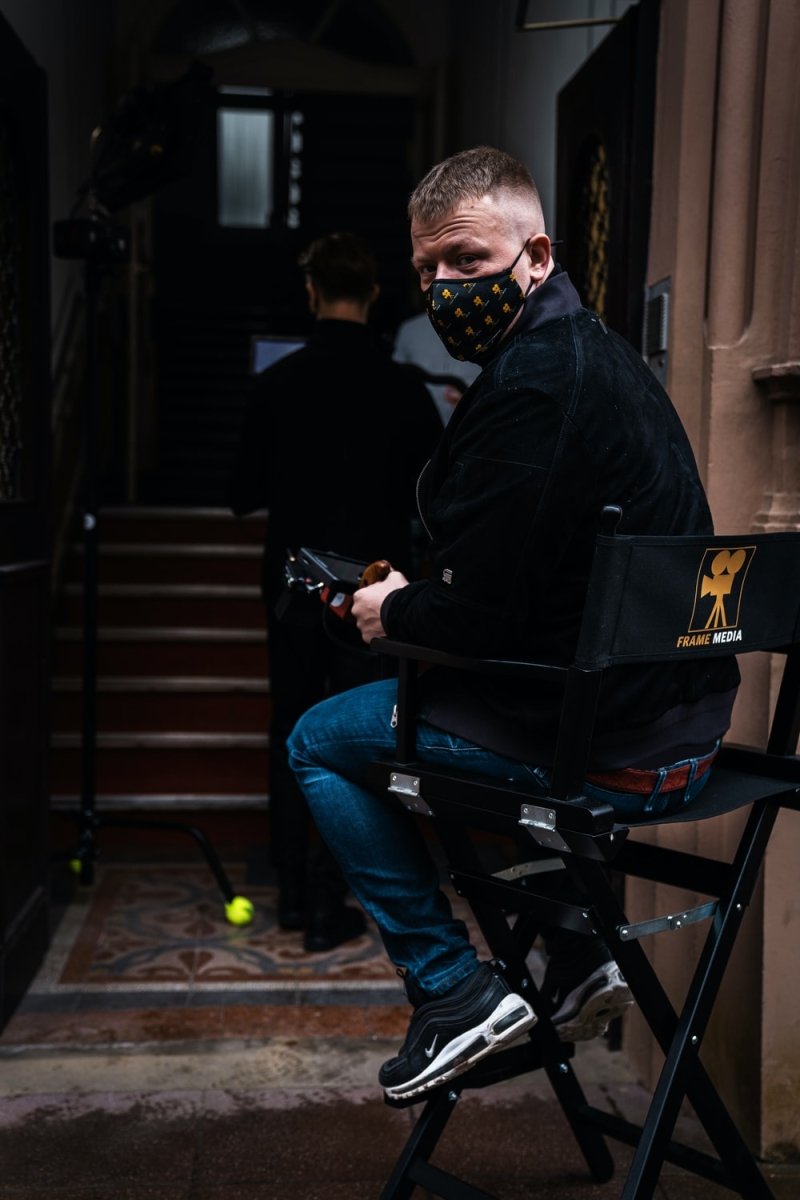 Paint By Numbers | Man In Black Jacket And Blue Denim Jeans Sitting On Black Metal Bench - Custom Paint By Numbers