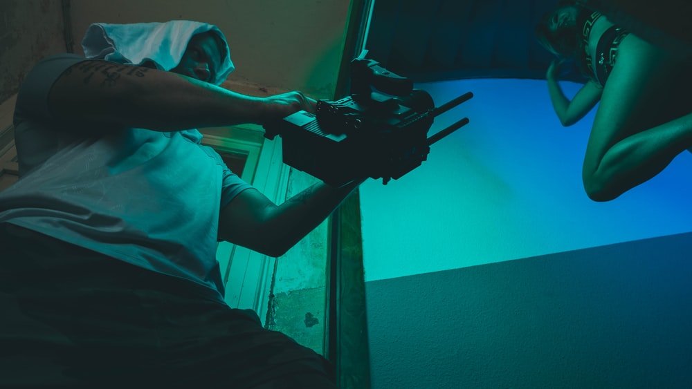 Paint By Numbers | Man In Teal Polo Shirt Holding Black Dslr Camera - Custom Paint By Numbers