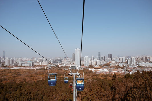 Paint By Numbers | Jinan - Cable Cars Over City Buildings During Daytime - Custom Paint By Numbers