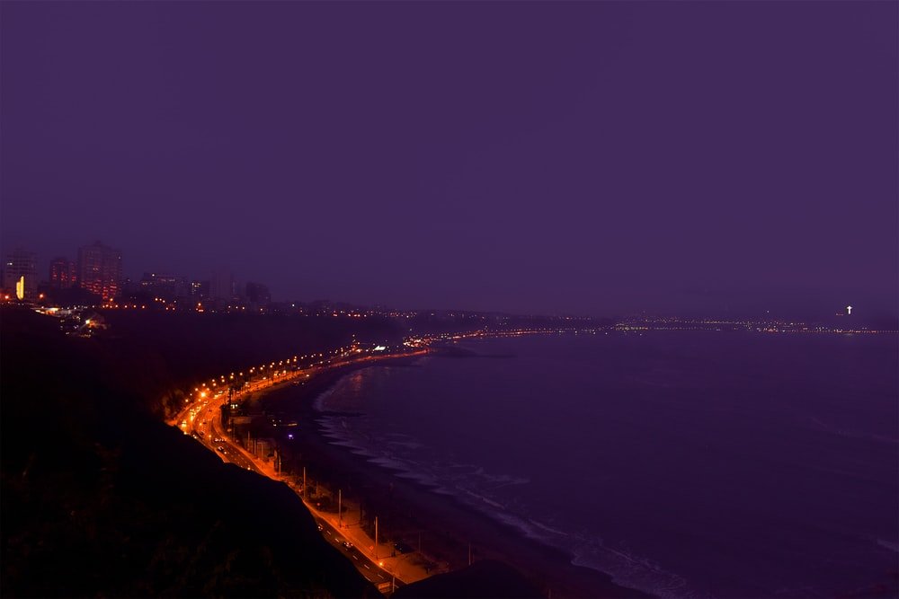Paint By Numbers | Lima - Lighted Building Near Sea During Nighttime - Custom Paint By Numbers