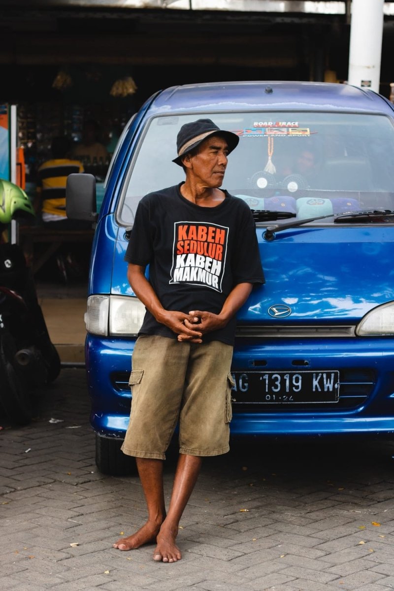 Paint By Numbers | Surabaya - Man Leaning On Blue Vehicle During Daytime - Custom Paint By Numbers