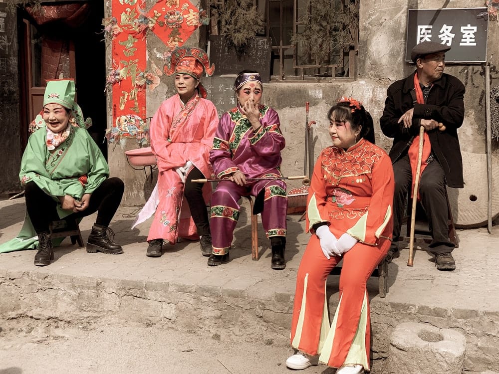 Paint By Numbers | Taiyuan - 3 Women In Red Traditional Dress Sitting On Concrete Bench - Custom Paint By Numbers