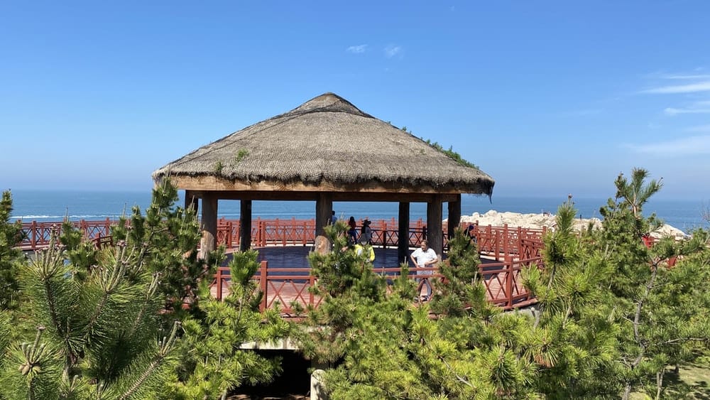 Paint By Numbers | Yantai - People Sitting On Brown Wooden Chairs Near Brown Wooden House Under Blue Sky During Daytime - Custom Paint By Numbers