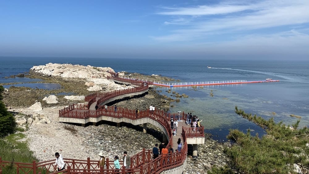 Paint By Numbers | Yantai - People Walking On Brown Concrete Bridge Near Body Of Water During Daytime - Custom Paint By Numbers